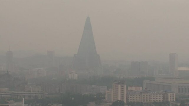 The pyramid-shaped Ryugyong hotel in the fog, Pyongyang, North Korea