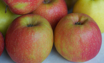 Red and yellow apples are piled up.