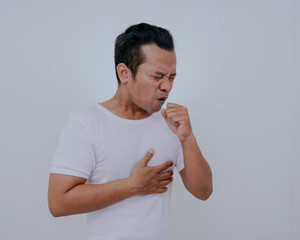 Strongly coughing young man wearing white t-shirt suffered from asthma, isolated on white...