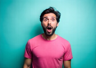 Fototapeta premium Man with Open Mouth Expressing Surprise Against Teal Background
