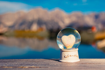 Crystal ball, with a heart inside, alpine autumn or indian summer shot at Mount Hartkaiser, Ellmau,...