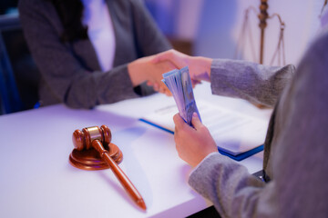 Business people shaking hands and exchanging money after signing a contract in a lawyer's office...