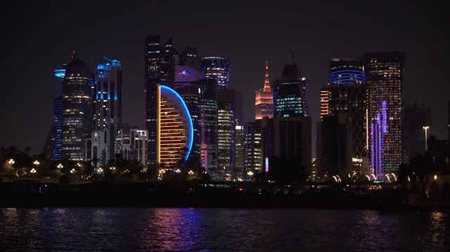 Panoramic night view of West Bay in Doha city. modern skyscrapers can be seen from the corniche