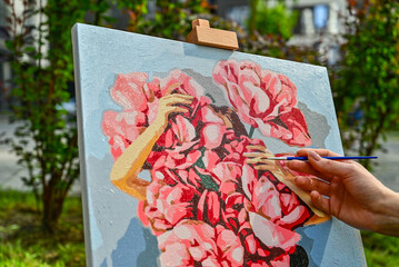 A colorful painting on an easel in a peaceful outdoor setting, with a brush nearby, capturing the...