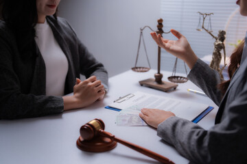 Two female lawyers are discussing legal issues and offering illegal money to a client in the...