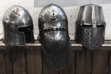 An intriguing display featuring three medieval helmets, crafted from steel