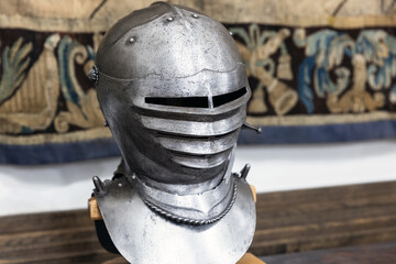 Fototapeta premium Iron forged medieval helmet displayed on a stand,