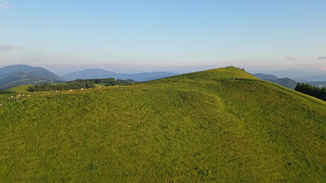 Aerial view of serene grazing pasture with rolling hills and clear sky, Sommeralm, Styria, Austria.