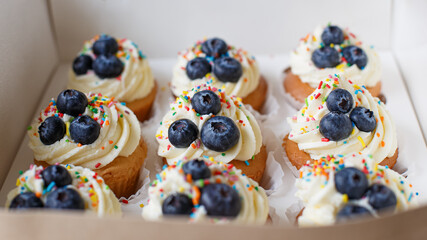 Cupcakes in a cardboard box. Confectionery products. Sweet pastries. Food and drinks.
