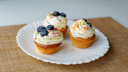 Cupcakes on a white plate. Confectionery products. Food and drinks. Sweet pastries.