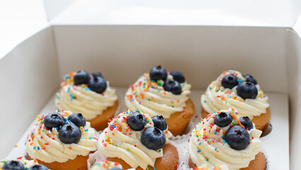 Cupcakes in a cardboard box. Confectionery products. Sweet pastries. Food and drinks.