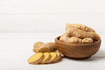 Fresh ginger on wooden background. Dry ginger. Sliced ​​ginger with honey and lemon. Ginger root. Traditional alternative medicine, healing tea for immunity. Seasoning and spices concept. Copy space.