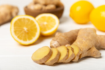 Fresh ginger on wooden background. Dry ginger. Sliced ​​ginger with honey and lemon. Ginger...