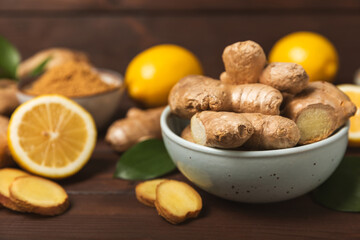 Fresh ginger on wooden background. Dry ginger. Sliced ​​ginger with honey and lemon. Ginger...
