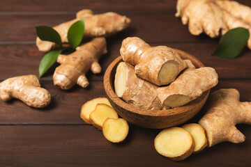 Fresh ginger on wooden background. Dry ginger. Sliced ​​ginger with honey and lemon. Ginger...