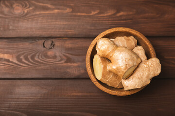 Fresh ginger on wooden background. Dry ginger. Sliced ​​ginger with honey and lemon. Ginger root. Traditional alternative medicine, healing tea for immunity. Seasoning and spices concept. Copy space.