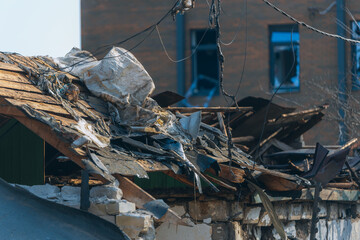 Consequences of military actions, destroyed building, close-up. Damage to walls, roof and windows...