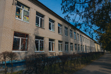 Consequences of military actions, destroyed building, close-up. Damage to walls, roof and windows is visible. Destruction of a residential building. War in Ukraine. Shelling of civilians.