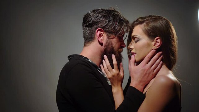 Couple in a passionate embrace. Sexy lovers. Romantic couple. Tender lovers gazing at each other. Intimate moment between man and woman. Woman seducing her boyfriend. Sensual couple face to face.