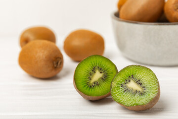 Kiwi on wooden background. Whole fruit and slices pieces of green kiwi on table. fresh ripe juicy...