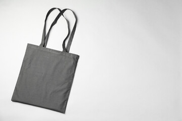 One shopping bag and space for text on grey background, top view. Mockup for design