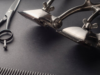 Vintage barber tools meticulously positioned on a dark surface showcase the craftsmanship involved...