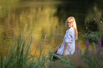 Portrait of a young beautiful blonde girl in nature.