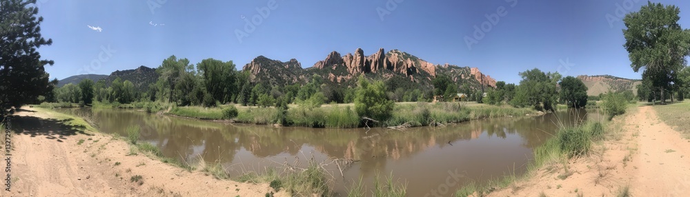 Poster a panoramic view of a river with a mountain range in the background