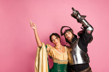 Royal Couple in Themed Carnival Dress With Pink Backdrop Showcasing Medieval and Elegant Vibes