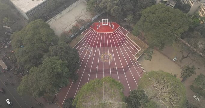 Aerial view of central shaheed minar surrounded by trees and park, Shahbag, Dhaka, Bangladesh.