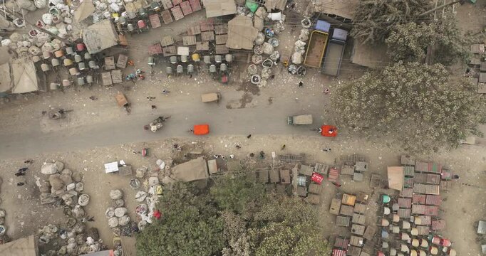 Aerial view of rubbish recycling activity in a busy urban market with vehicles and people, Dhaka, Dhaka Province, Bangladesh.