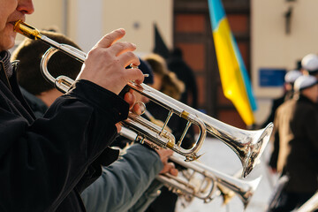 Talented musicians perform an elegant outdoor brass concert, playing French horns with skill and...