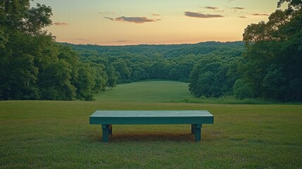 Obraz premium Empty park bench at sunset overlooking a valley