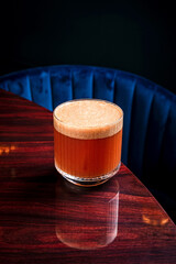 An alcoholic foamy cocktail in a lowball rocks glass