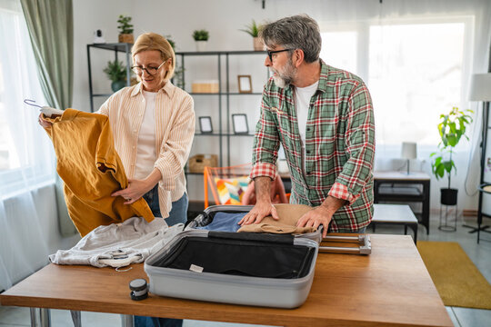 woman help man to pack suitcase baggage prepare for vacation holiday