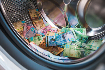 Obraz premium A pile of tenge bills lies in the drum of a washing machinet