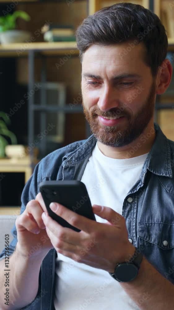 Wall mural smiling mature business man entrepreneur or trader using mobile phone device sitting on sofa at mode