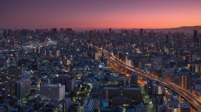 osaka city center aerial view timelapse night to day high rise buildings skyline,high point of view time lapse of urban modern cityscape at sunrise dawn