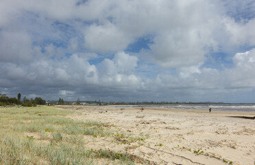 Aerial views of muddy waters from Cudgen Creek after Cyclone Alfred flowing in to the sea at Kingscliff headland seawall along the east coast of New South Wales, Australia
