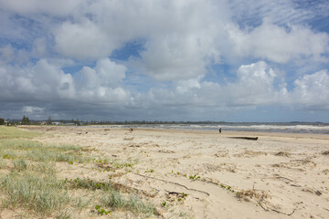 Aerial views of muddy waters from Cudgen Creek after Cyclone Alfred flowing in to the sea at Kingscliff headland seawall along the east coast of New South Wales, Australia