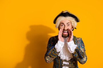 Man in vintage aristocratic costume with a vibrant yellow background expressing excitement