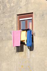 Colorful drape spread over the fabric of a windowv