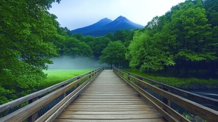 Fototapeta premium A rustic wooden bridge, nestled amid lush green trees and misty mountains, crosses a peaceful river, inviting exploration.