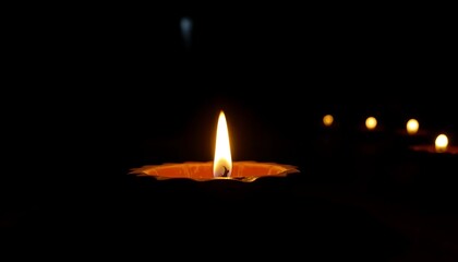 A single illuminated candle in the darkness, surrounded by softly glowing lights, creating a serene and spiritual ambiance.