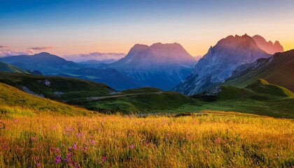 Obraz premium serene mountain landscape at dawn with majestic peaks and open field