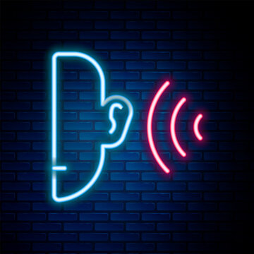 Glowing neon line Ear listen sound signal icon isolated on brick wall background. Ear hearing. Colorful outline concept. Vector