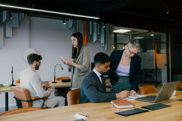 A group of creative business people are busy working in a modern office.