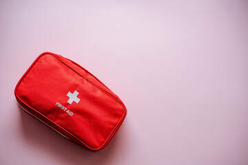 This Compact Red First Aid Kit on a Soft Pink Background is the perfect solution for Emergency...