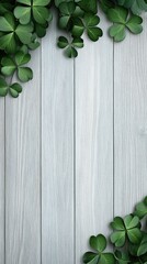 Decorative green shamrocks frame a white wooden board, creating a festive atmosphere for St. Patricks Day celebrations in spring