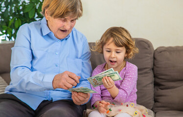 Old woman with her granddaughter. Selective focus.